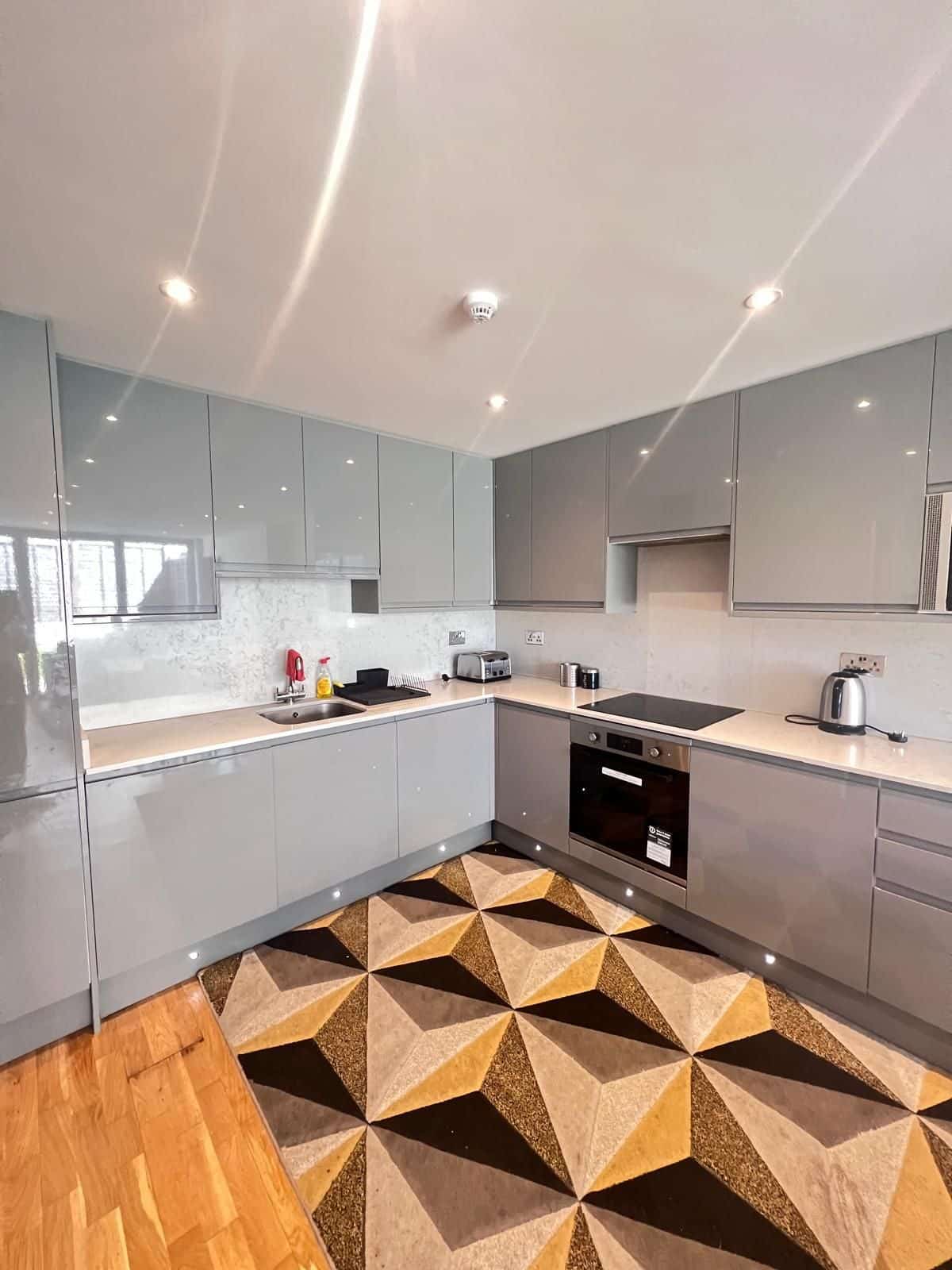 Fitted kitchen with patterned floor