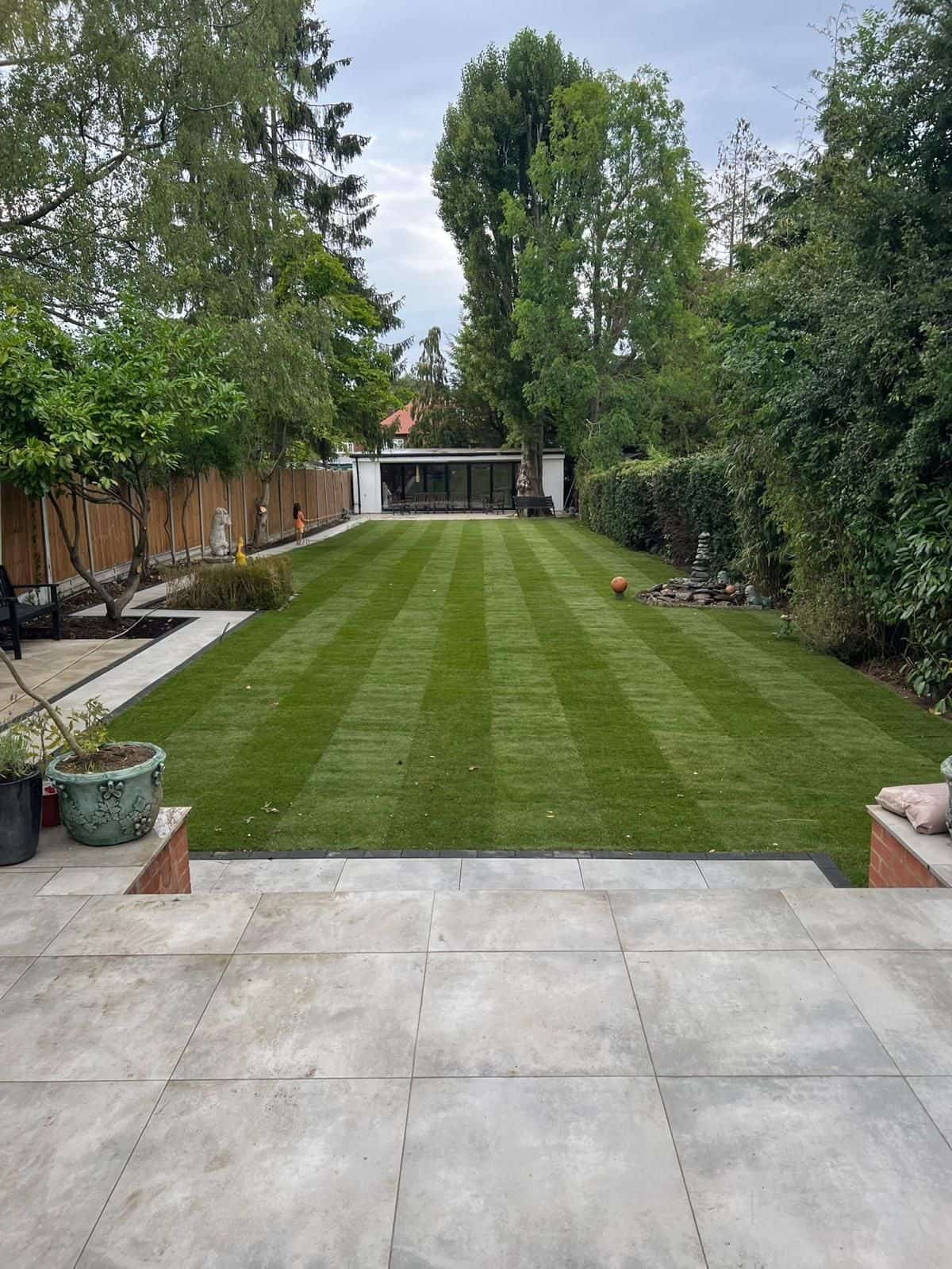 New patio and landscaped garden, with the garden building at the far end