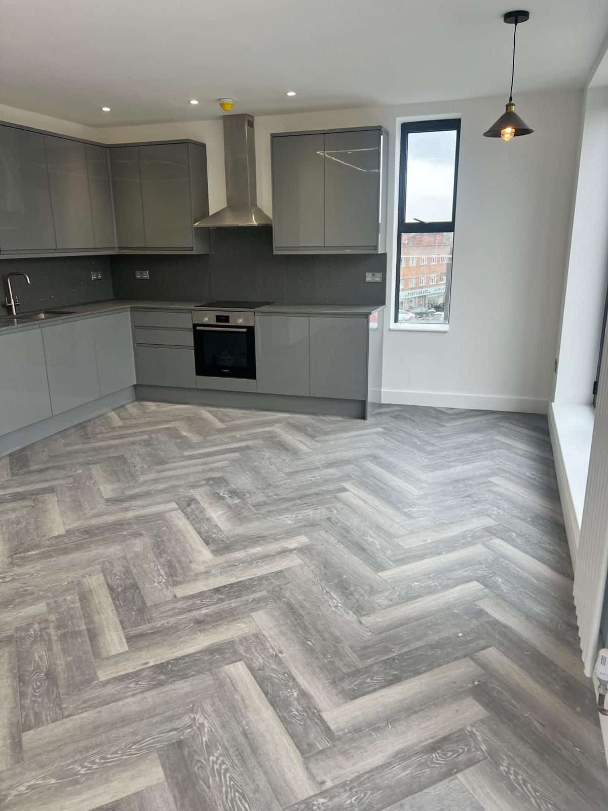 Fitted kitchen with herringbone flooring