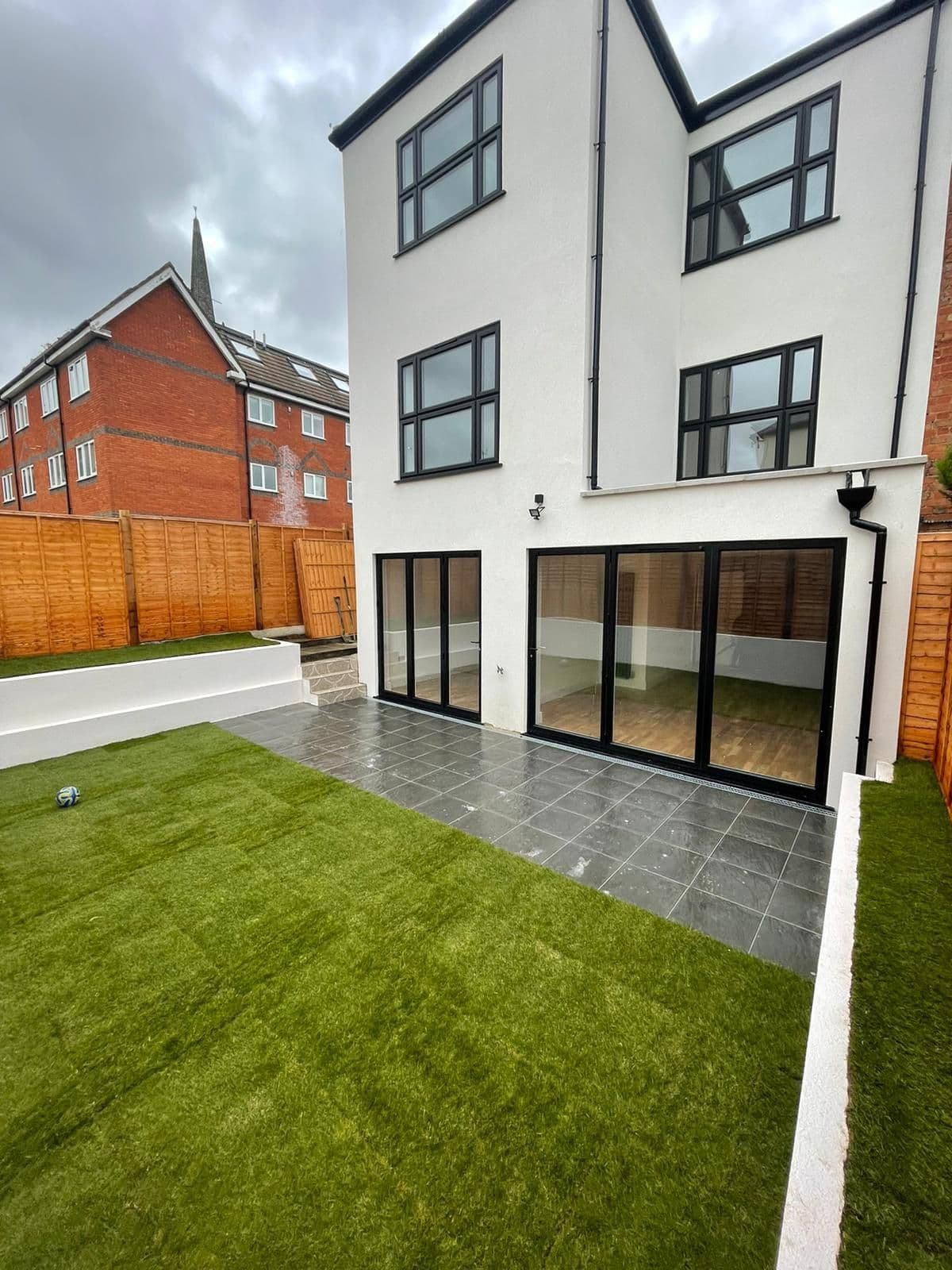 The finished three-storey rear extension and the lower-ground flat's garden