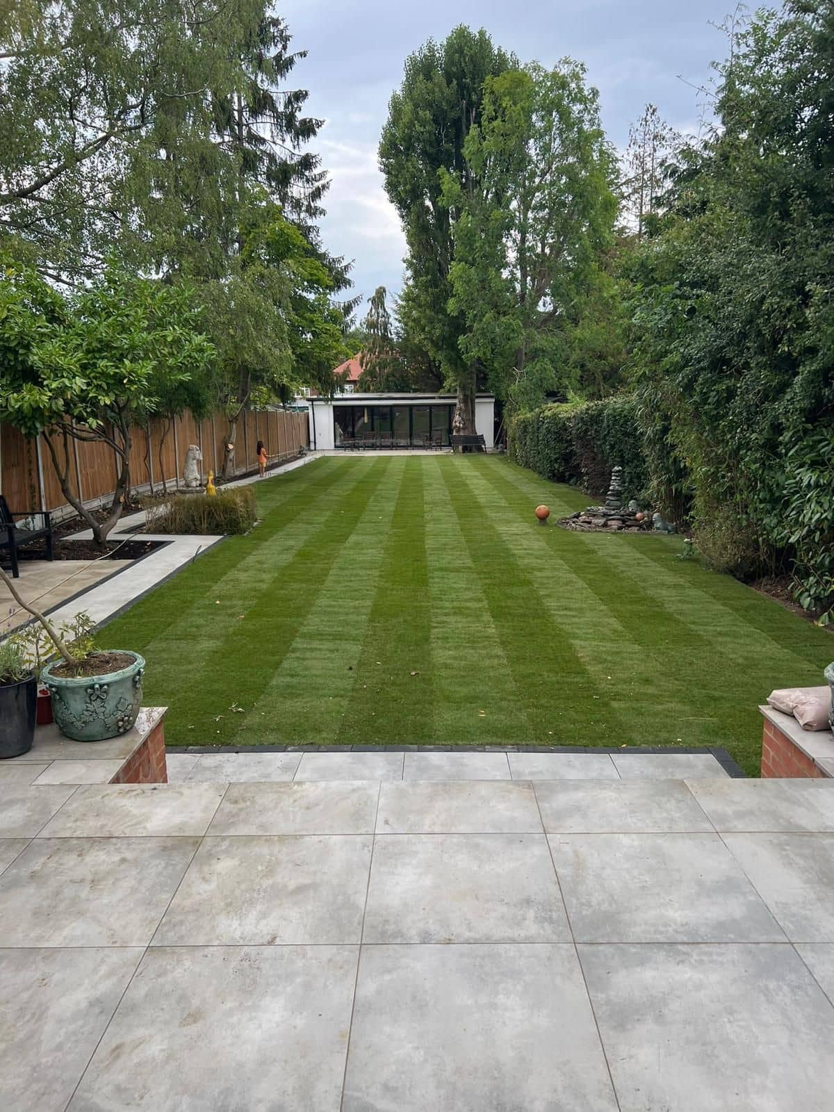 New patio and landscaped garden, with the garden building at the far end